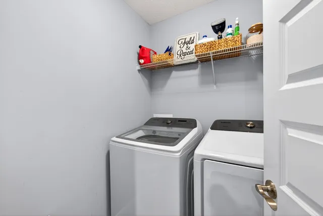 a bedroom with furniture and a large window