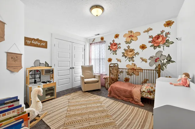 a bathroom with a granite countertop toilet sink and mirror
