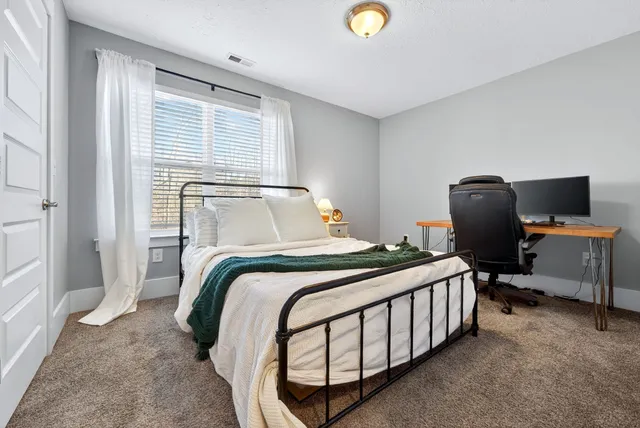 a bathroom with a granite countertop toilet sink and mirror