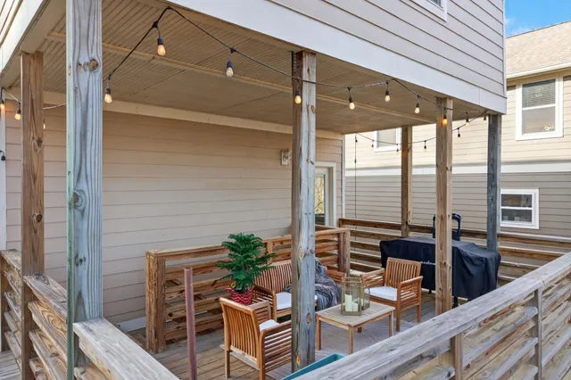 a view of a house with a patio and wooden fence