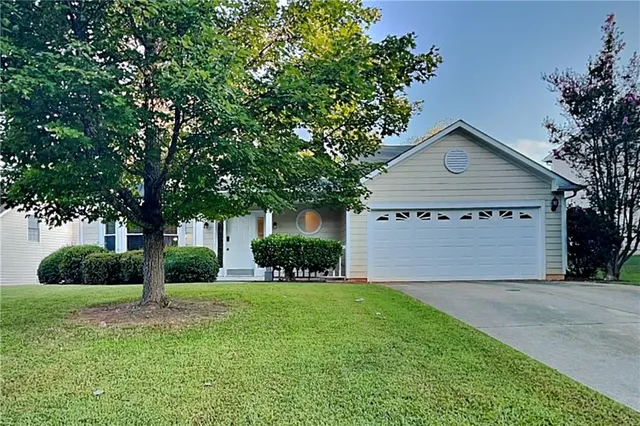 a view of a house with yard and tree s