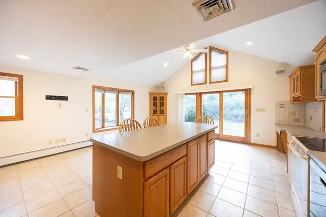 a kitchen with stainless steel appliances granite countertop a sink and a refrigerator