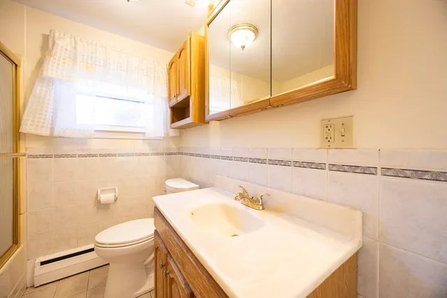 a bathroom with a sink a toilet and mirror