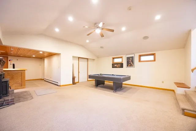 a view of an empty room with a window and fireplace