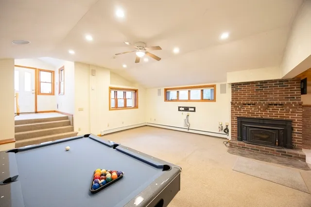 an empty room with windows and fireplace