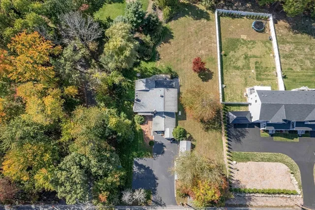 an aerial view of residential houses with outdoor space and parking
