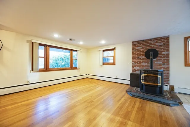 a view of a livingroom with furniture workspace and a window
