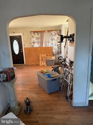 a living room with a couch and a stove next to a window