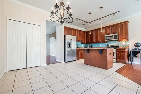 a kitchen with stainless steel appliances granite countertop a refrigerator and a stove top oven