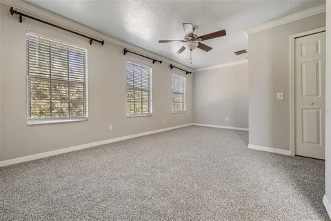 a view of a livingroom with a ceiling fan and window