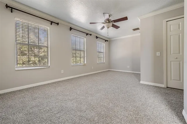 a view of a livingroom with a ceiling fan and window