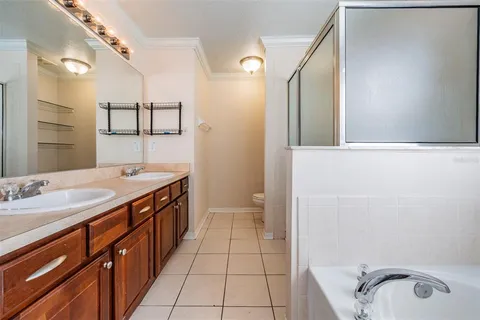 a bathroom with a sink a toilet and mirror