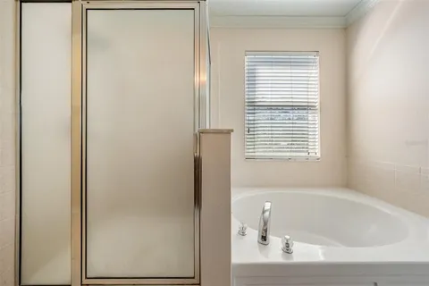 a spacious bathroom with a bathtub and a shower
