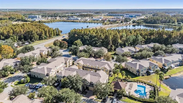 an aerial view of a house with a yard swimming pool and outdoor seating