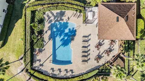 a room with gym equipment and wooden floor