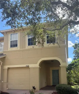 a front view of a house with plants