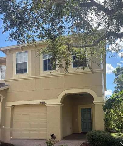 a front view of a house with plants