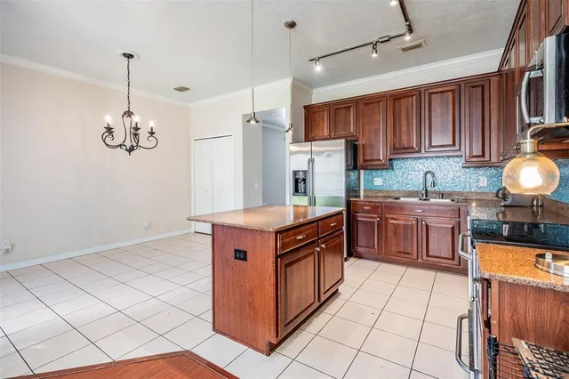 a kitchen with stainless steel appliances granite countertop a stove a sink dishwasher and a refrigerator