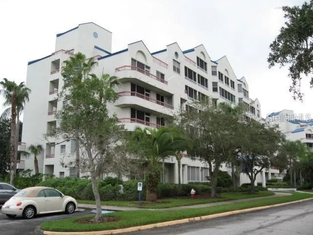 a view of a building with a yard and plants