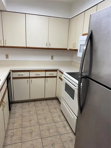 a kitchen with a sink a microwave and cabinets