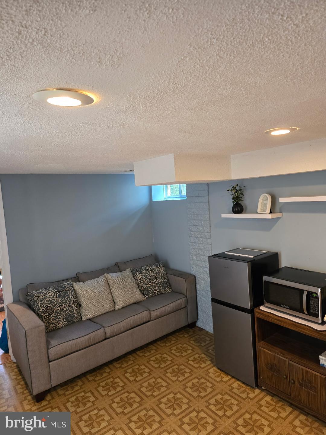 8512 Imperial Drive, Unit 1H Laurel, MD 20708 - Photo 11 of 14 a living room with a couch and a coffee table