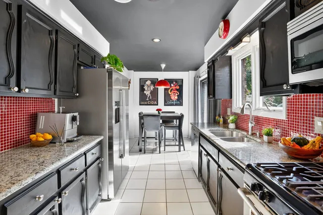 a kitchen with stainless steel appliances granite countertop a stove and a refrigerator