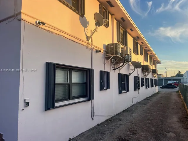 a hallway with wooden floor and a large window