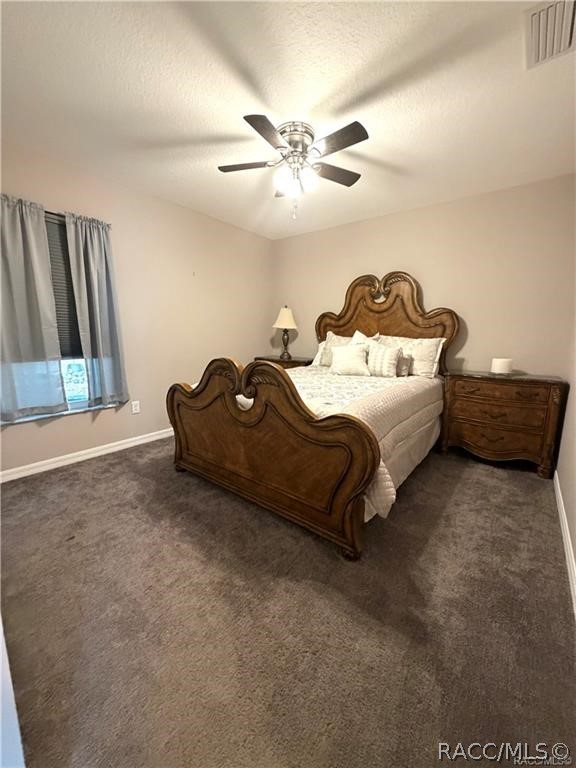 13591 Southwest 112th Street Dunnellon, FL 34432 - Photo 15 of 24 a spacious bedroom with a bed and a chandelier