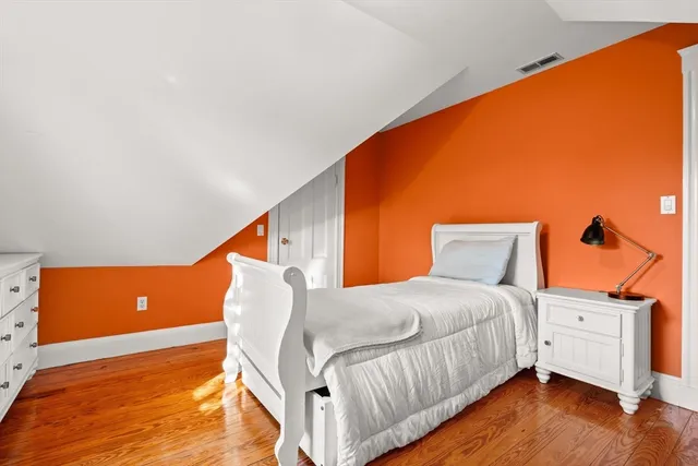 a bedroom with a bed and a night stand