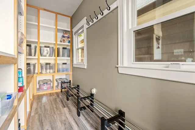 a view of a room with furniture and wooden floor