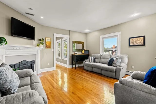a living room with furniture fireplace and flat screen tv