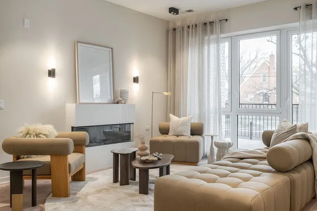 a bedroom with furniture and a large window