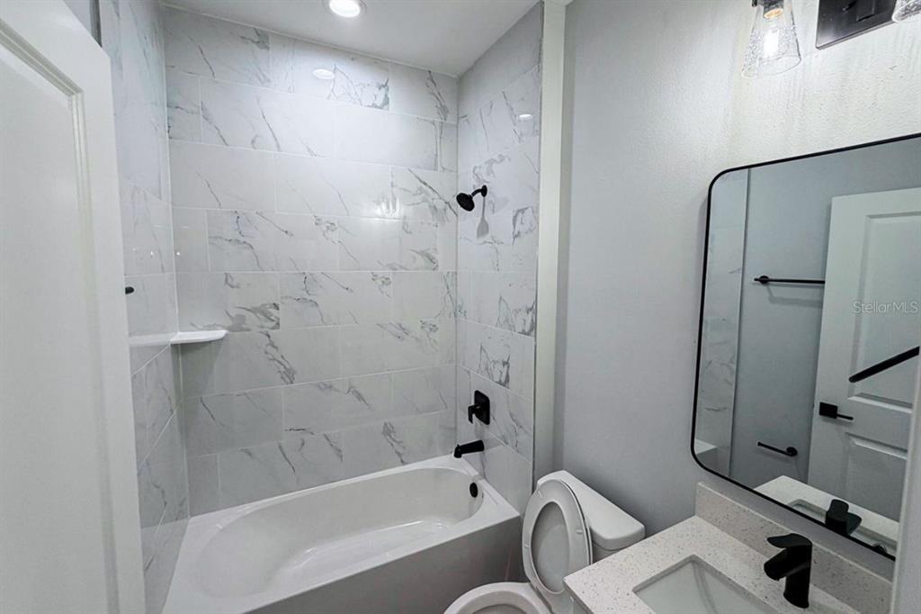 3100 Crowder Street Punta Gorda, FL 33980 - Photo 4 of 6 a bathroom with a bathtub a toilet and a shower