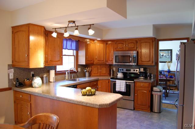 466 Nolf Road Nazareth, PA 18064 - Photo 5 of 27 a kitchen with stainless steel appliances wooden cabinets sink and stove