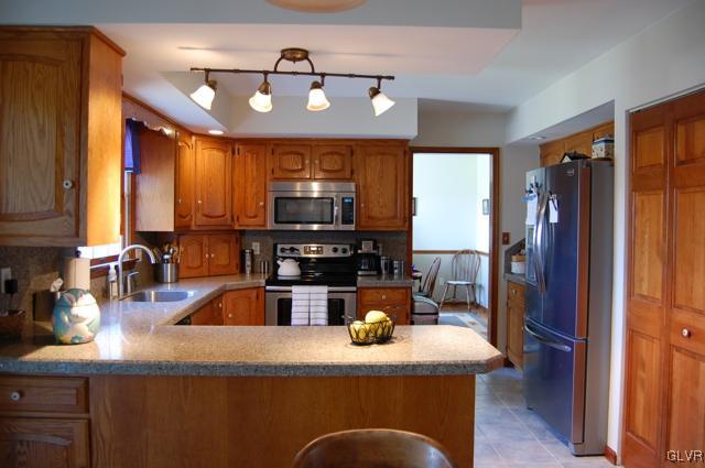 466 Nolf Road Nazareth, PA 18064 - Photo 6 of 27 a kitchen with kitchen island granite countertop a sink cabinets and stainless steel appliances