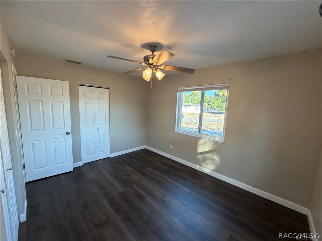 405 Copperfield Road Spring Hill, FL 34606 - Photo 19 of 25 an empty room with wooden floor and windows