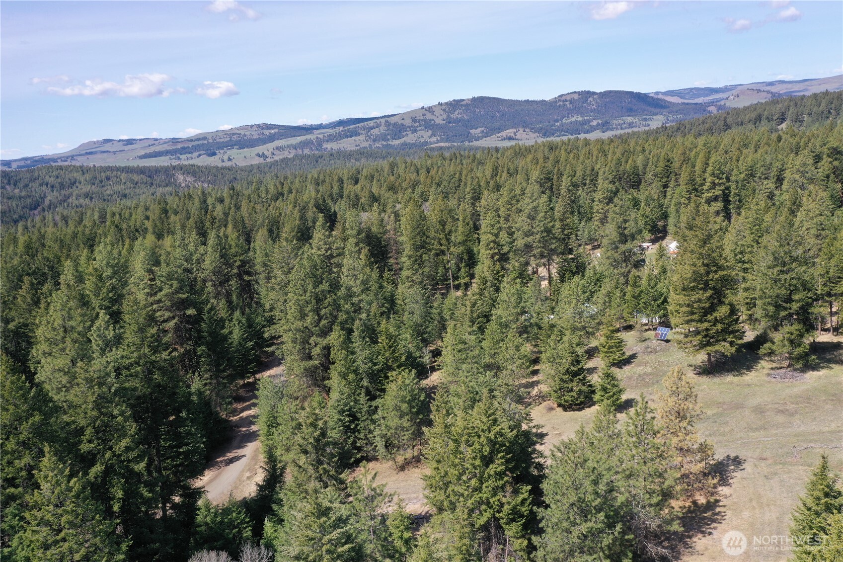 65A Spring Meadow Lane Oroville, WA 98844 - Photo 11 of 40 a view of a lush green hillside and a houses