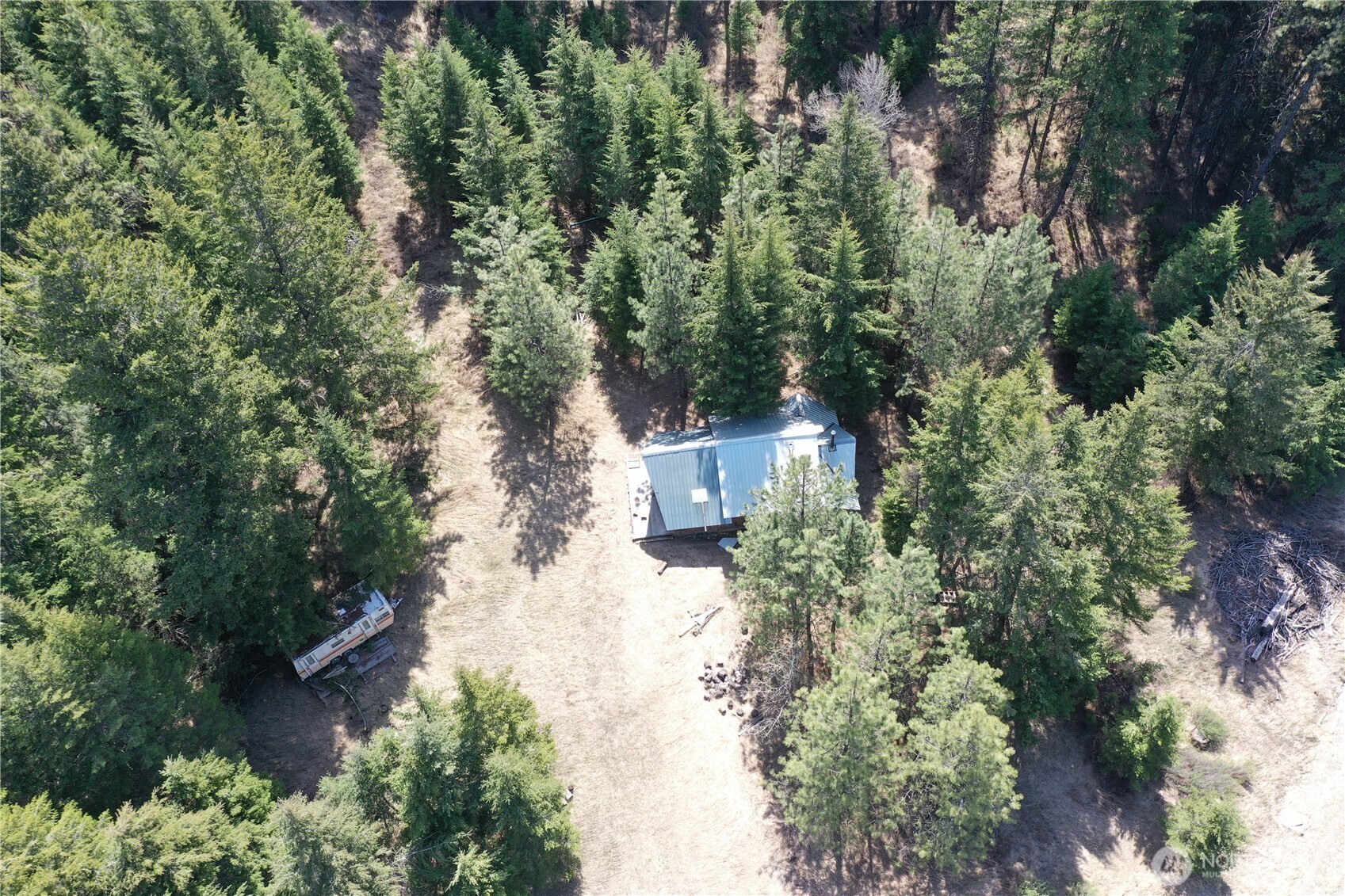 65A Spring Meadow Lane Oroville, WA 98844 - Photo 19 of 40 an aerial view of a house with a yard and large trees