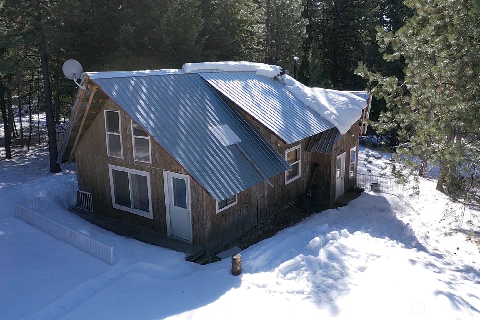 65A Spring Meadow Lane Oroville, WA 98844 - Photo 26 of 40 a view of backyard with deck and outdoor seating