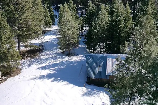 a view of house with yard and sitting area