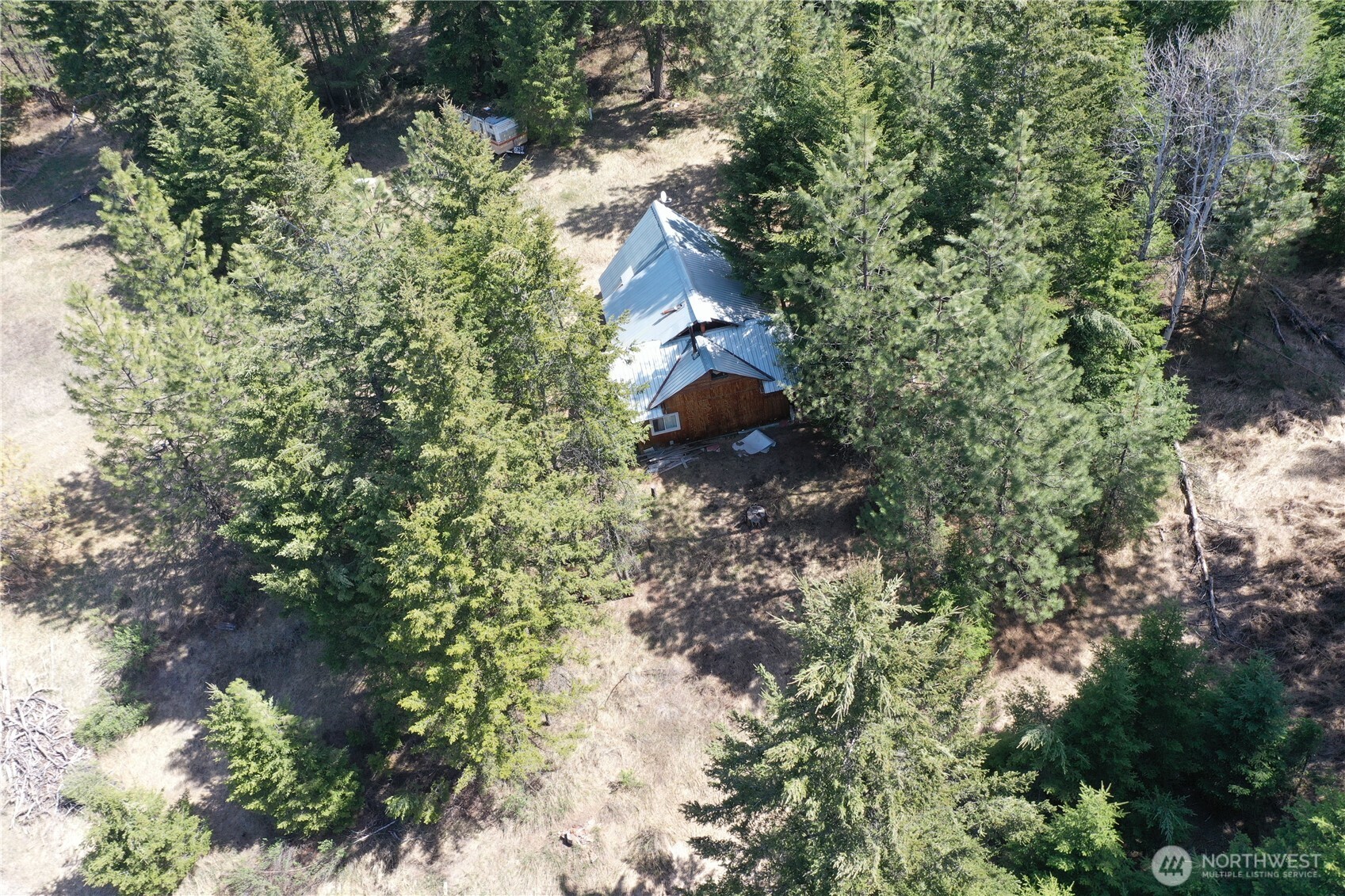 65A Spring Meadow Lane Oroville, WA 98844 - Photo 7 of 40 a backyard of a house with lots of green space
