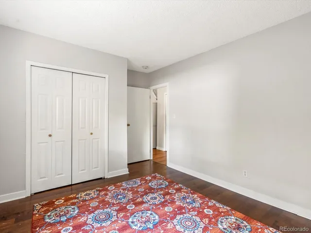 an empty room with wooden floor and window