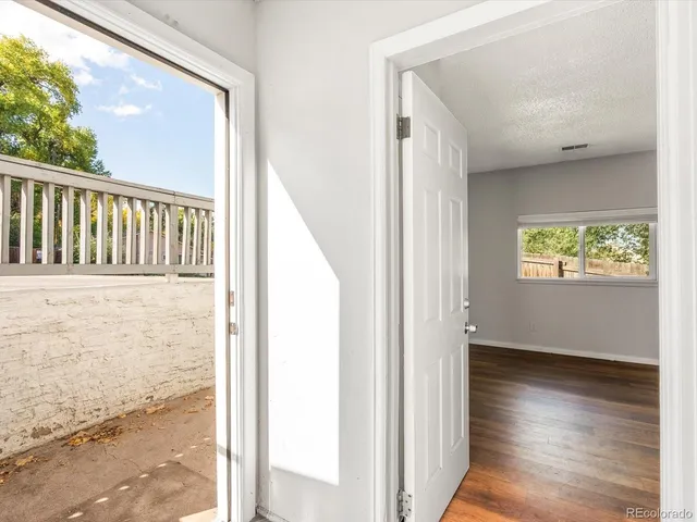 a view of empty room with wooden floor