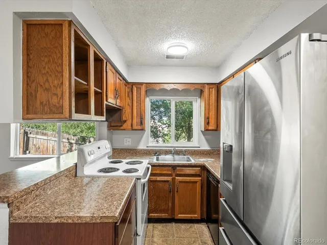a bathroom with a granite countertop sink and a window
