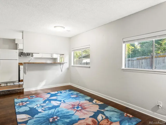 a room with wooden floor and natural light