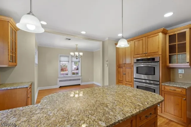a kitchen with kitchen island granite countertop a stove and refrigerator