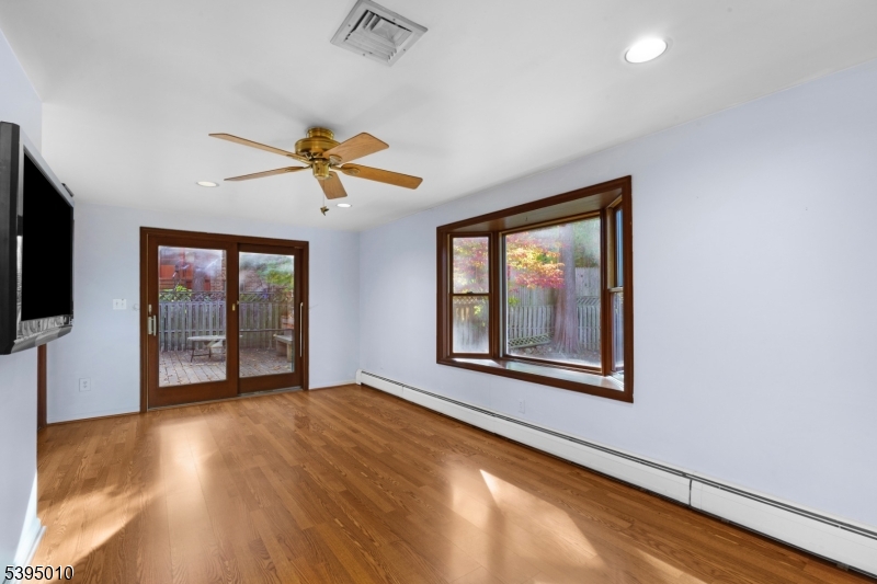 654 Suffern Road Teaneck, NJ 07666 - Photo 13 of 30 a view of an empty room with a window and wooden floor