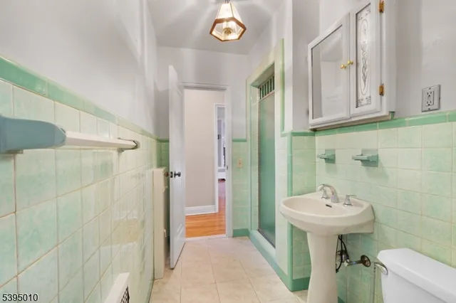 a bathroom with a sink a mirror and a shower