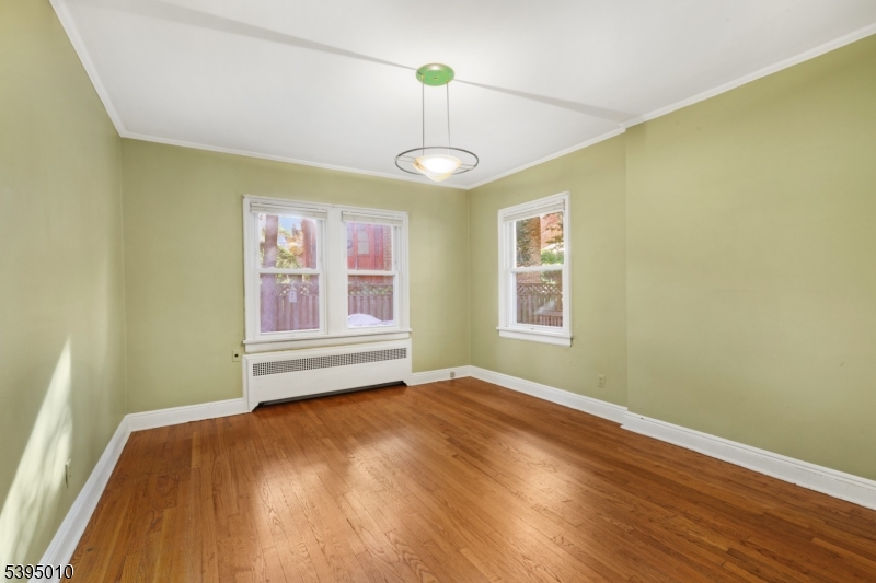 654 Suffern Road Teaneck, NJ 07666 - Photo 16 of 30 a view of an empty room with wooden floor and a window