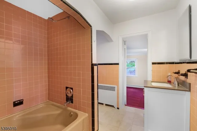 a bathroom with a tub and a sink